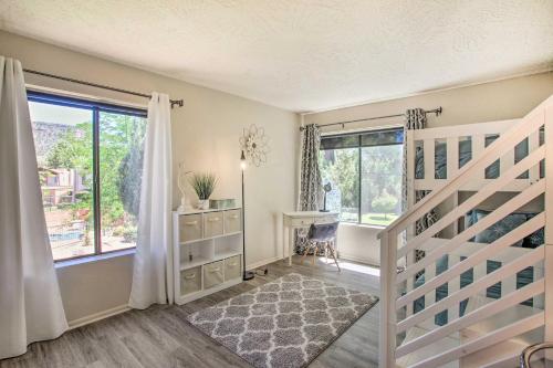 a bedroom with a staircase and a large window at Bright Sedona Condo Resort-Style Amenities! in Sedona