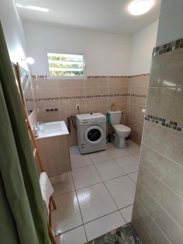 a small bathroom with a toilet and a sink at Les Naïades in Goyave