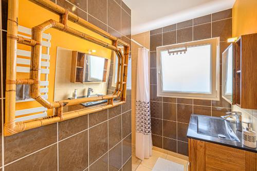 a bathroom with a sink and a mirror at AUX AQUARELLES DE LINETTE in Tréffiagat