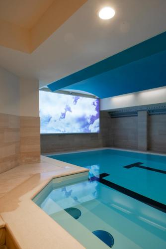 a swimming pool with a large window in a house at Perugia Park Hotel in Perugia