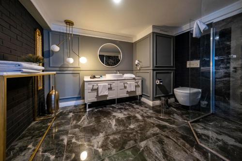 a bathroom with a sink and a toilet and a shower at B LOFT HOTEL in Bursa