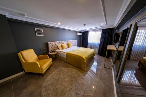 a hotel room with a bed and a chair at B LOFT HOTEL in Bursa