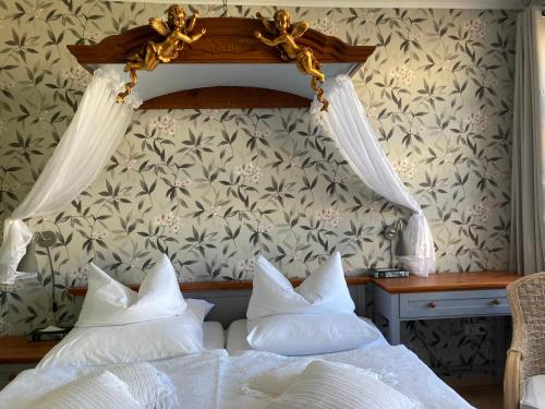 a bedroom with a bed with white pillows at Villa Harmonie in Lohme