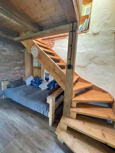 a bed in a log cabin with a staircase at Myczkowianka Sadyba in Uherce Mineralne (7)