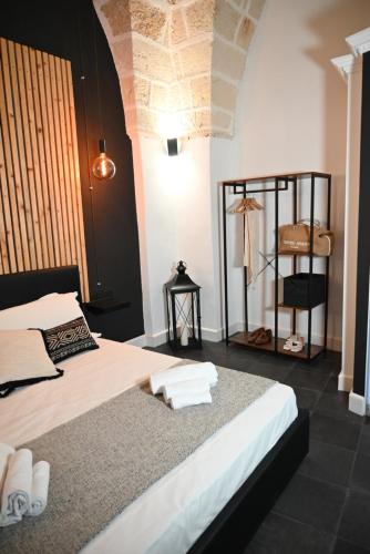 a bedroom with a bed with towels on it at Poesìa in Brindisi