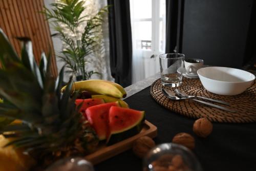 a table with a pineapple and a plate of fruit at Poesìa in Brindisi