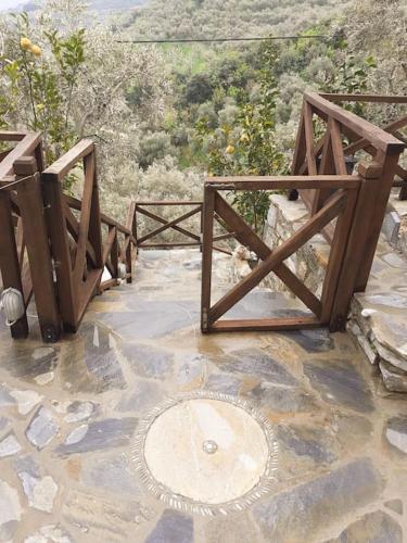 a wooden bridge with a man hole in the ground at LIMNIONAS SUNVIEW in Xorychti