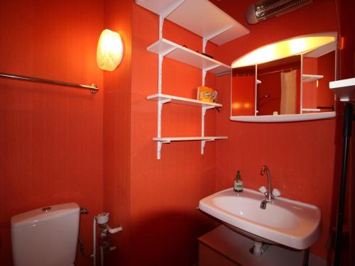 a bathroom with a sink and a toilet and a mirror at Studio Chamrousse, 1 pièce, 4 personnes - FR-1-549-75 in Chamrousse