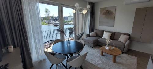 a living room with a couch and a table at Apartamentai AQUA in Palanga