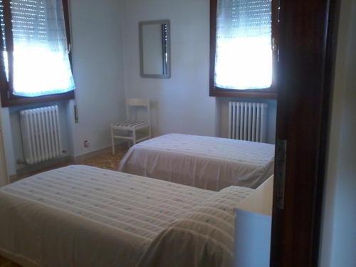 um quarto com 2 camas e 2 janelas em Casa Mary venezia lido em Lido di Venezia