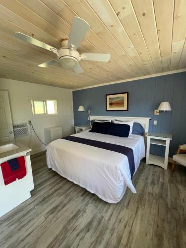 a bedroom with a large bed and a ceiling fan at Grandview Motel in Tobermory