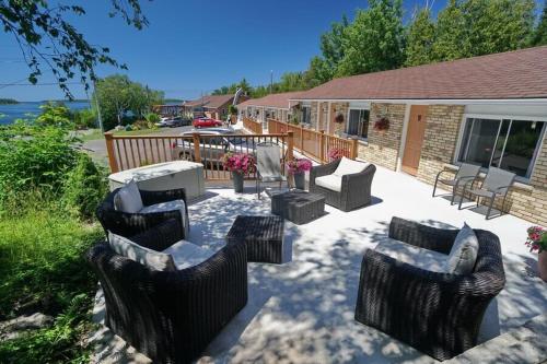 a patio with couches and chairs and a table at Grandview Motel in Tobermory