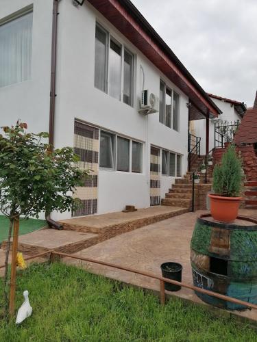 a home with a patio and a house at La Colette in Dubova