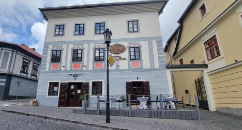 a building with a street light in front of it at Hotel Salamander - Garni in Banská Štiavnica