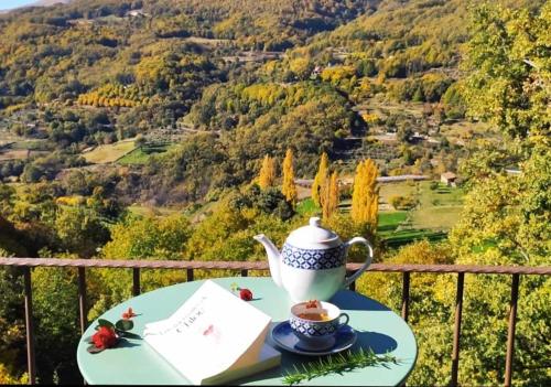 a teapot and a cup of tea on a table at Apartamentos La Rosa y El Pastor in Guijo de Santa Bárbara