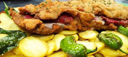 a plate of food with fried chicken and vegetables at LA CASONA DE PALMIRA in Caín