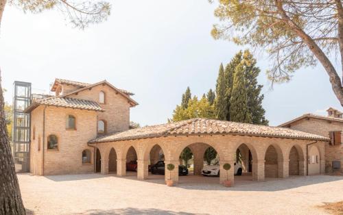 a large building with an archway in a courtyard at Miataland in Collazzone