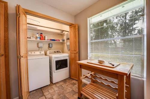 a kitchen with a washer and dryer next to a window at Rainey 5577 in Orange Park