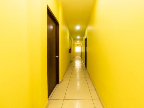 an empty hallway with yellow walls and a yellow ceiling at Hotel Santa Cruz, San Juan de los Lagos in San Juan de los Lagos