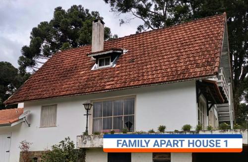 a small white house with a red roof at Bongusto Apart House Locações Mantiqueira in Monte Verde