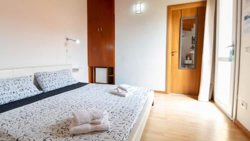 a bedroom with a bed with two towels on it at Spapparra B&B in Càbras