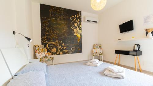 a bedroom with a bed and a black and gold wall at Spapparra B&B in Càbras