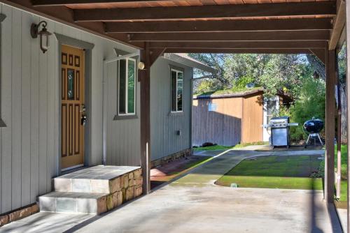 a porch of a house with a wooden pergola at Bass Alley Bungalow Experience Wc Lodging in Lower Lake