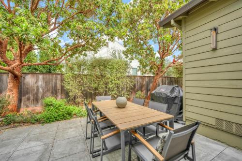 a wooden table and chairs on a patio at Heavenly Hideaway A Wine Country Escape in Healdsburg