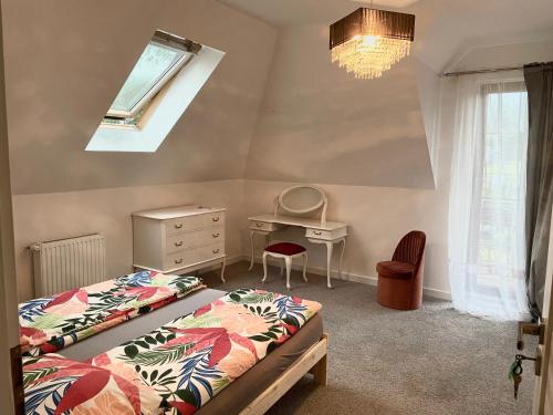 a bedroom with two beds and a desk and a window at Hostel Wilanów in Warsaw