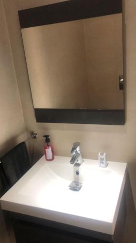 a bathroom sink with a large mirror above it at Diar Mira in Kelibia