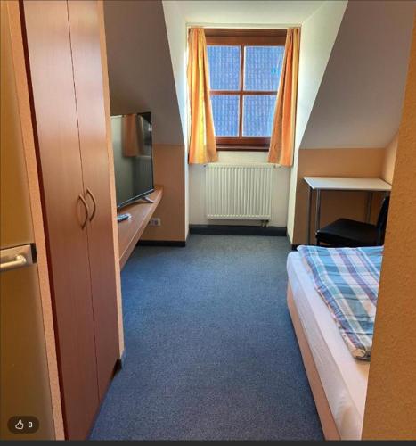 a hotel room with a bed and a window at Pension Klosterhof in Ebelsbach