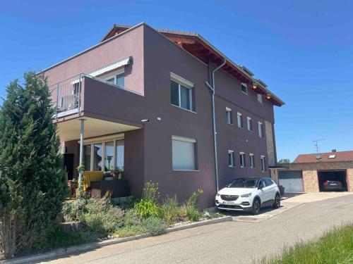 a house with a car parked in front of it at Ferienwohnung Falke in Meckenbeuren