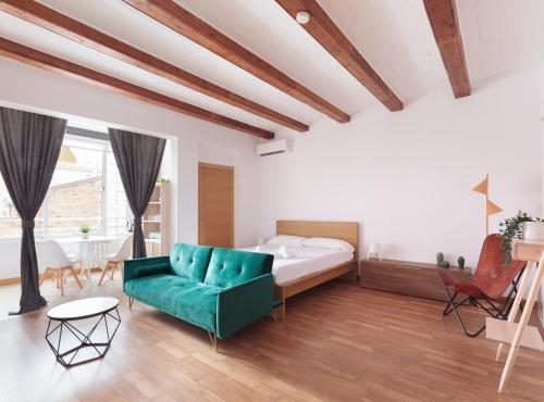 a bedroom with a bed and a green couch at Guadiana · Apartment 2x1, near Sants station in Barcelona