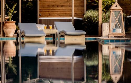 a pool with two lounge chairs and a table at Artemis Villas - Spectacular Views & Ideal For Large Groups, By ZanteWize in Khartáta