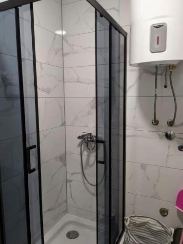 a shower with a glass door in a bathroom at Blue harmony 1 Malinska in Malinska