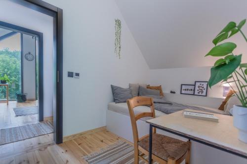 a living room with a table and a couch at Czarny domek w górach in Pieszyce