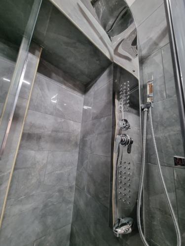 a shower in a bathroom with a glass shower stall at B&b casa (le porte di napoli) in Naples