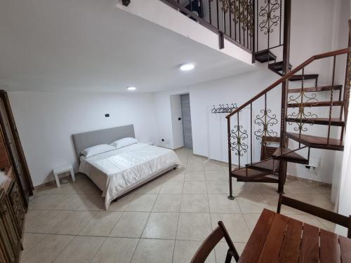 a bedroom with a bed and a staircase at B&b casa (le porte di napoli) in Naples