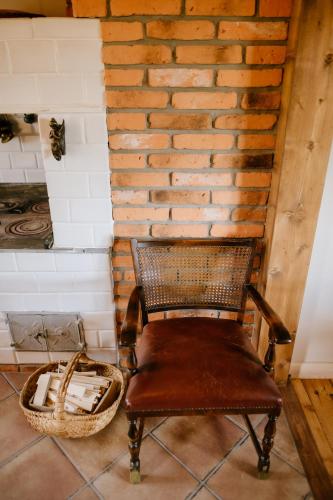 a chair sitting in a room with a brick wall at Piękne Pole in Łaziska