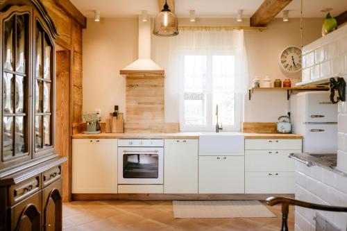 a kitchen with white appliances and a window at Piękne Pole in Łaziska
