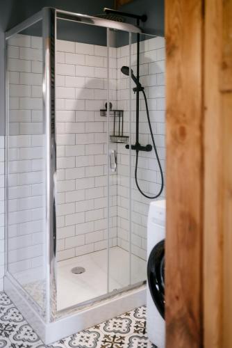 a shower with a glass door in a bathroom at Piękne Pole in Łaziska