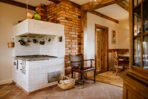 a kitchen with a brick wall and an oven at Piękne Pole in Łaziska