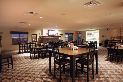 a restaurant with tables and chairs in a room at Arbuckle Lodge Gillette in Gillette