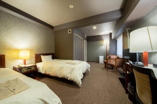 Posteľ alebo postele v izbe v ubytovaní Hotel New Carina