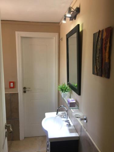 a bathroom with a sink and a mirror at Cabañas Los 4 elementos - Uspallata in Las Heras