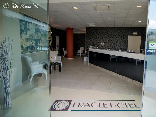 a lobby of a hotel with a reception desk and chairs at Eracle Hotel in Volla