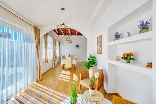 a living room with white walls and a large window at Villa Pacis in Benkovac