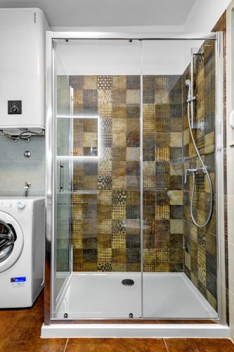 a shower with a glass door in a bathroom at Villa Pacis in Benkovac