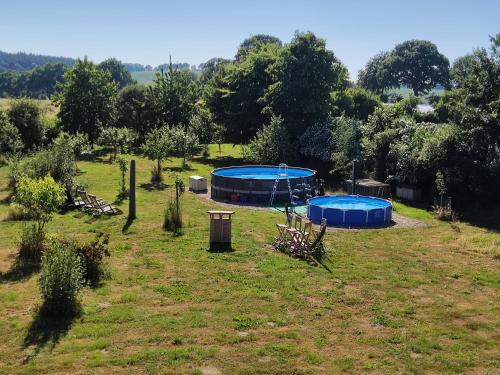 a yard with two trampols in a field at Five Oaks - Grüne Wohnung in Hohenkirchen