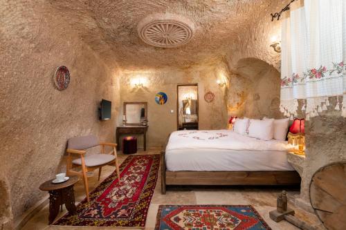 a bedroom with a bed in a stone room at Kayata Cave Suites Special Class in Urgup